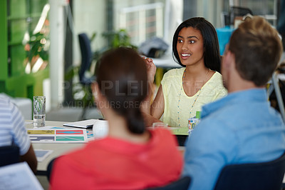 Buy stock photo Shot of a group of designers discussing work in a meeting