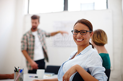 Buy stock photo Portrait of a young female designer in a meeting with her colleagues