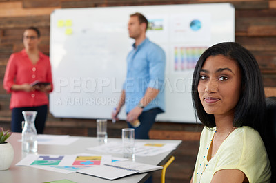 Buy stock photo Portrait of an attractive young woman sitting in a presentation by two of her colleagues