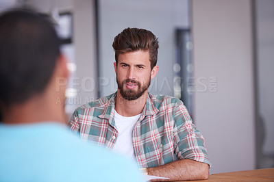 Buy stock photo Shot of a handsome young man working in his office
