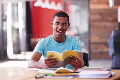 Buy stock photo Shot of a college student laughing while reading a book