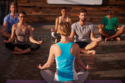 Buy stock photo Shot of a yoga instructor instructing her class