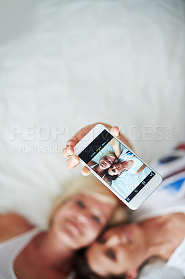 Buy stock photo Lesbian couple, women and selfie with phone screen, romance and relationship with happiness. House, queer people and marriage with picture, lgbtq and social media with memory, relaxing and comfort