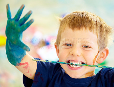 Buy stock photo Boy, paint and mess or playing portrait, happy child in preschool or childhood fun. Educational development, smile and finger or face painting for art, recreation activity for growth together