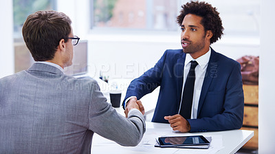 Buy stock photo Shot of businessmen shaking hands in an office