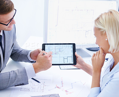 Buy stock photo Shot of a male and female architect working on a digtial tablet