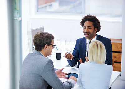 Buy stock photo Shot of a businessman having a positive discussion with colleagues
