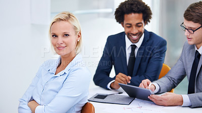 Buy stock photo Shot of a confident businesswoman with colleagues behind her