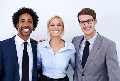 Buy stock photo Portrait of three happy colleagues smiling confidently at the camera