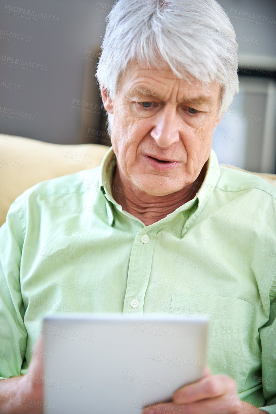 Buy stock photo Tablet, sofa and senior man in home on internet for social media, website and online entertainment. Retirement, relax and elderly person on digital tech for search, reading news and connection