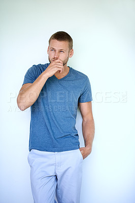 Buy stock photo Model, thinking and fashion in studio for confidence, style and aesthetic with trendy casual wear. Male person, cool and vision on white background for relaxed outfit, clothes and tshirt with idea