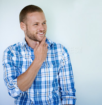 Buy stock photo Handsome man, thinking or fashion with style or confidence in studio on a white background. Young, casual model or masculine male person with smile in wonder, thought or contemplating in blue tshirt