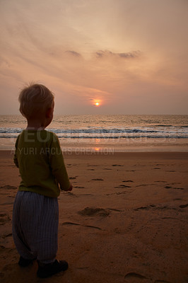 Buy stock photo Sunset, boy and child on beach for vacation, adventure and explore by waves on summer holiday outdoor. Travel, male person and kid by seaside for playing, wellness and journey in nature on weekend