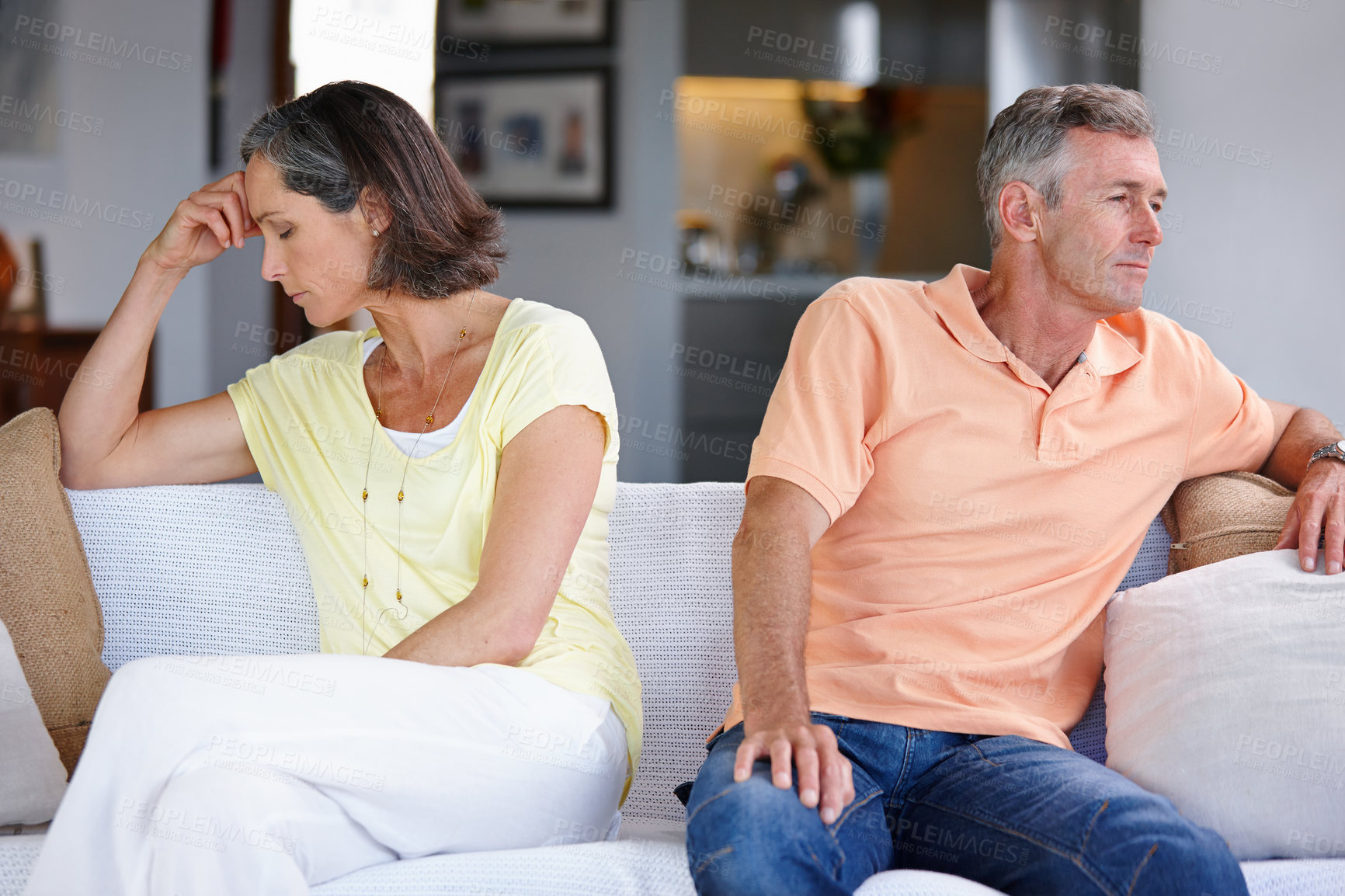Buy stock photo Shot of a mature couple ignoring each other after having an argument