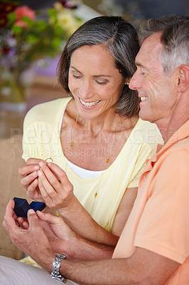 Buy stock photo Elderly couple, ring and engagement proposal in home for relationship, commitment and romance. Senior people, happy and jewelry for hand in marriage question, love and future promise with box on date