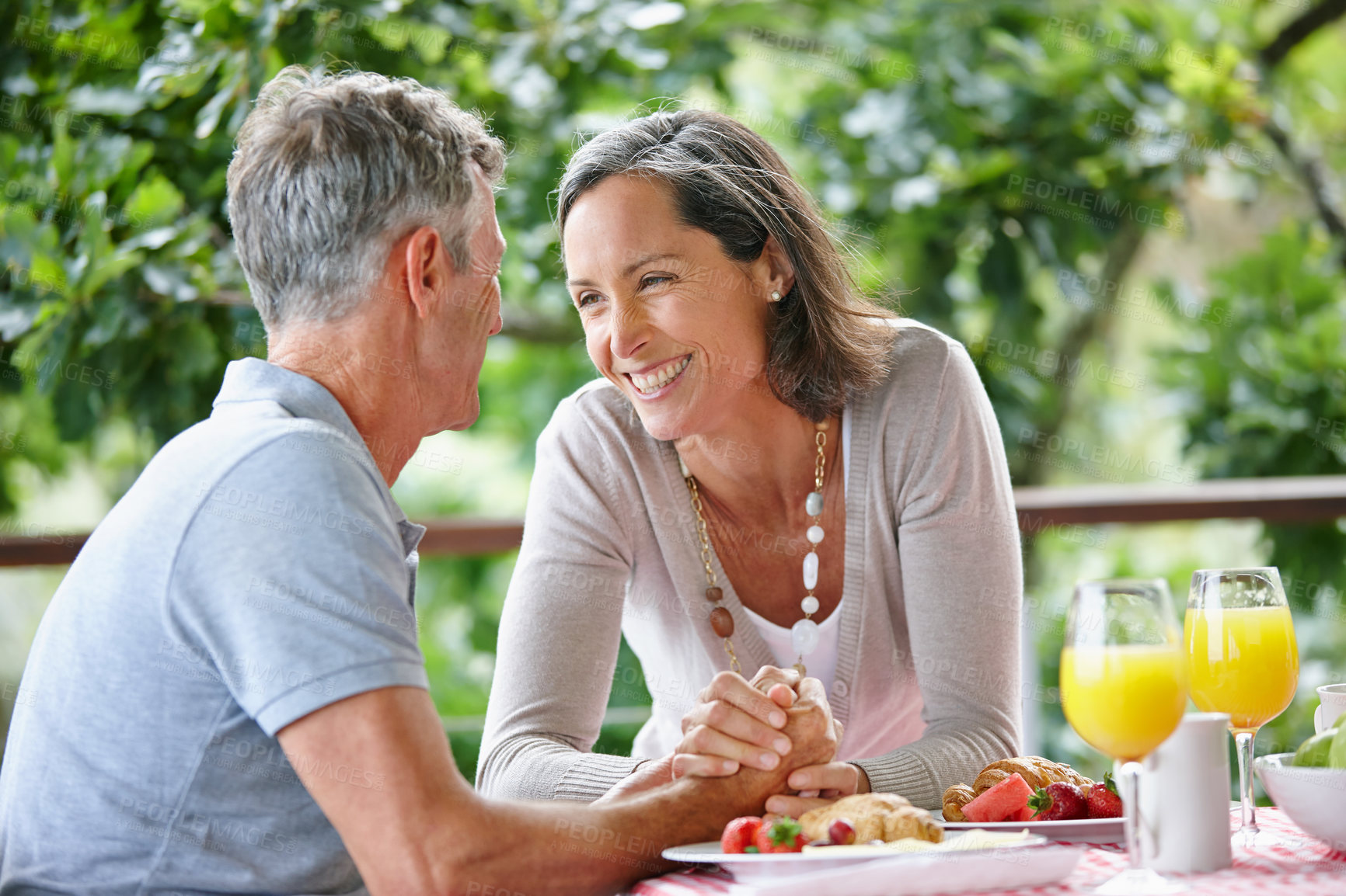 Buy stock photo Outdoor, holding hands and senior couple with breakfast, care and bonding together with conversation. Happy, mature man and woman with smile, love and healthy meal with relationship and marriage