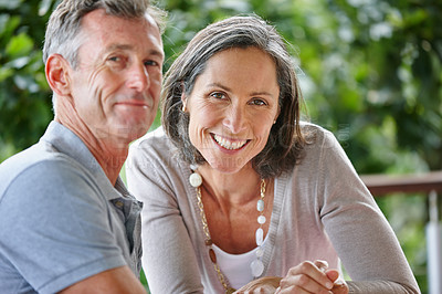 Buy stock photo Portrait of a loving mature couple sitting together outdoors