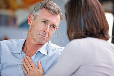 Buy stock photo Shot of woman consoling her husband at home