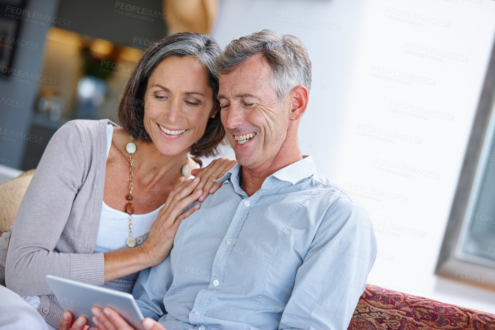 Buy stock photo Couch, mature couple and love with tablet for online joke, comedy film and streaming on website. Marriage, woman and man with digital subscription to watch movie, laughing or bonding together at home