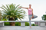 Shot of an attractive mature woman doing yoga outdoors