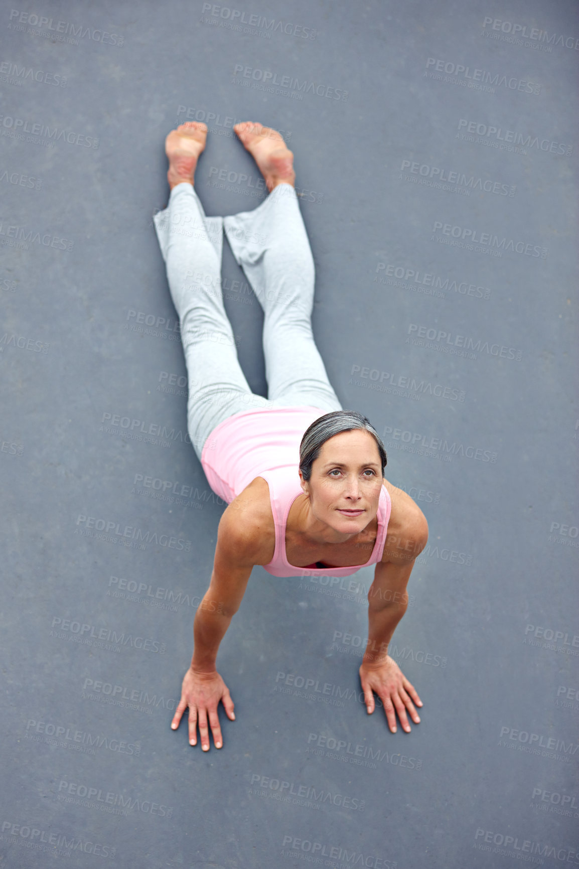 Buy stock photo Full length shot of an attractive mature woman practicing yoga outdoors