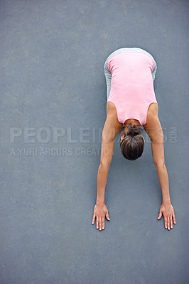 Buy stock photo High angle view of an attractive mature woman doing yoga outdoors