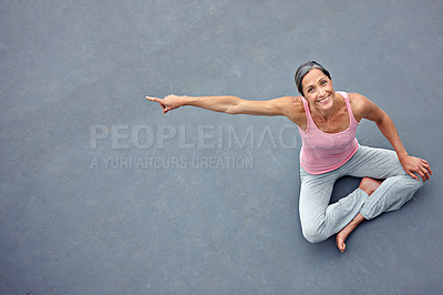 Buy stock photo Smile, yoga and portrait of mature woman pointing to space on gray floor background above. Happy, pilates and person show advertising mockup for fitness, yogi or exercise for healthy body in top view