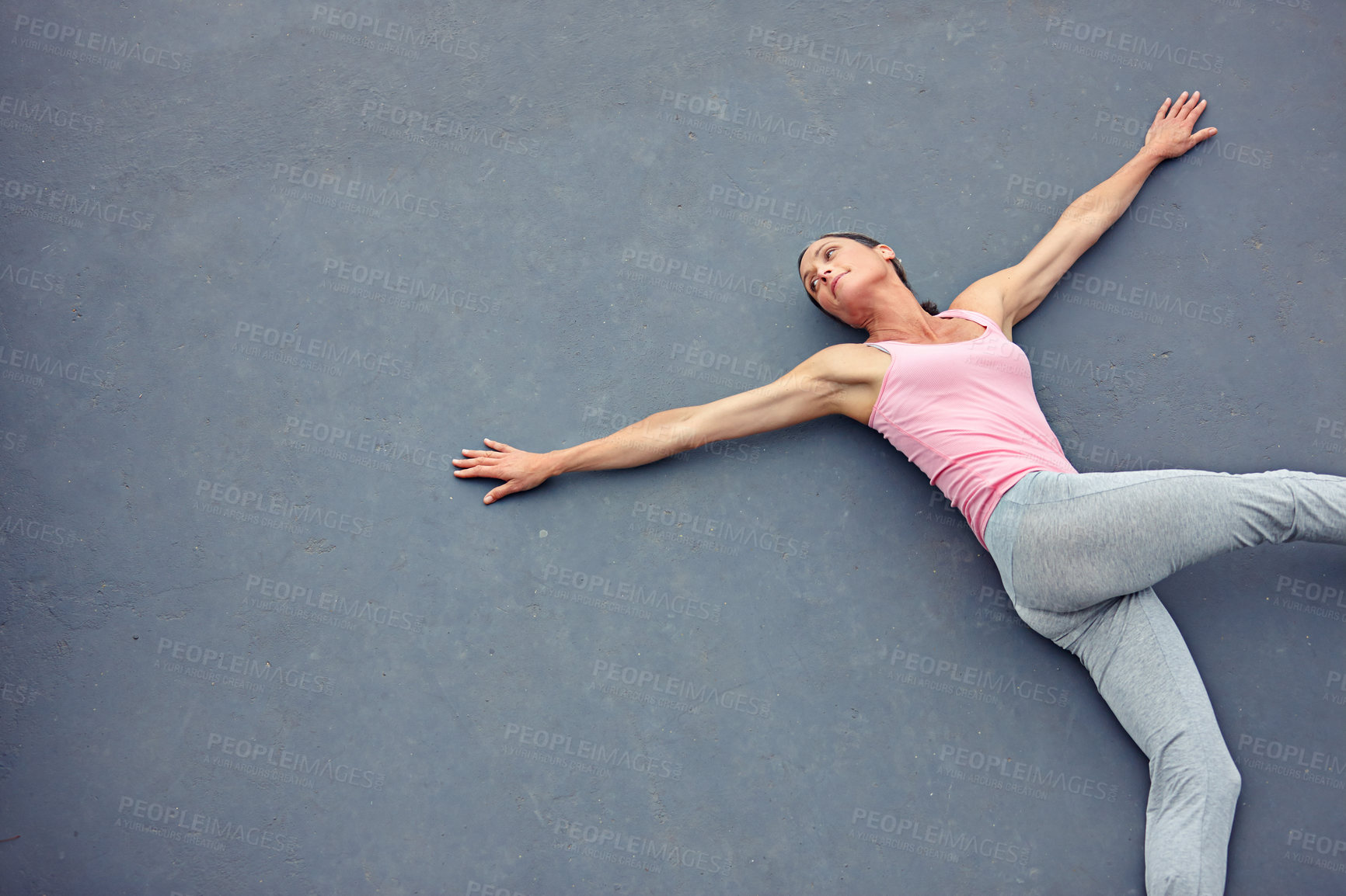 Buy stock photo High angle shot of an attractive mature woman doing yoga outdoors