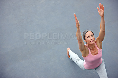 Buy stock photo High angle shot of an attractive mature woman doing yoga outdoors