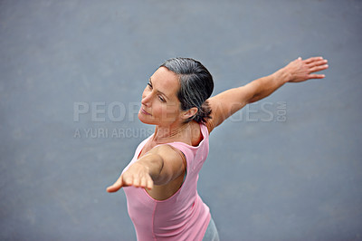 Buy stock photo High angle shot of an attractive mature woman doing yoga outdoors