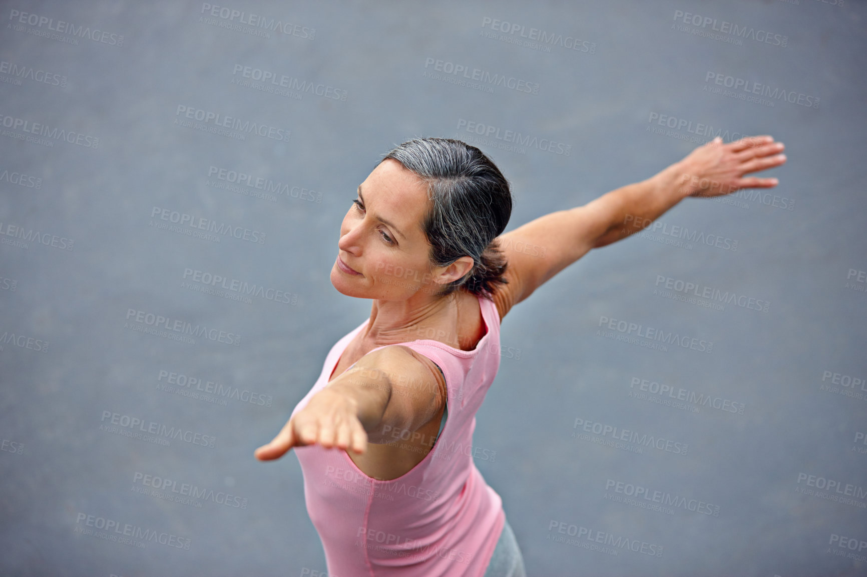 Buy stock photo High angle shot of an attractive mature woman doing yoga outdoors