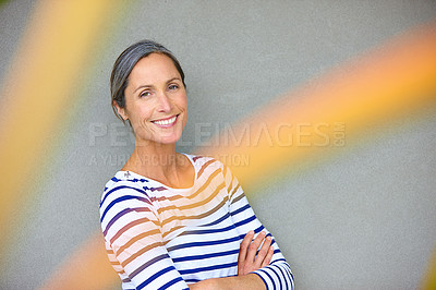 Buy stock photo Arms crossed, portrait and smile with mature woman on gray background in studio for fashion or style. Clothes, flare and stripes with happy person on mockup space to model outfit or wardrobe