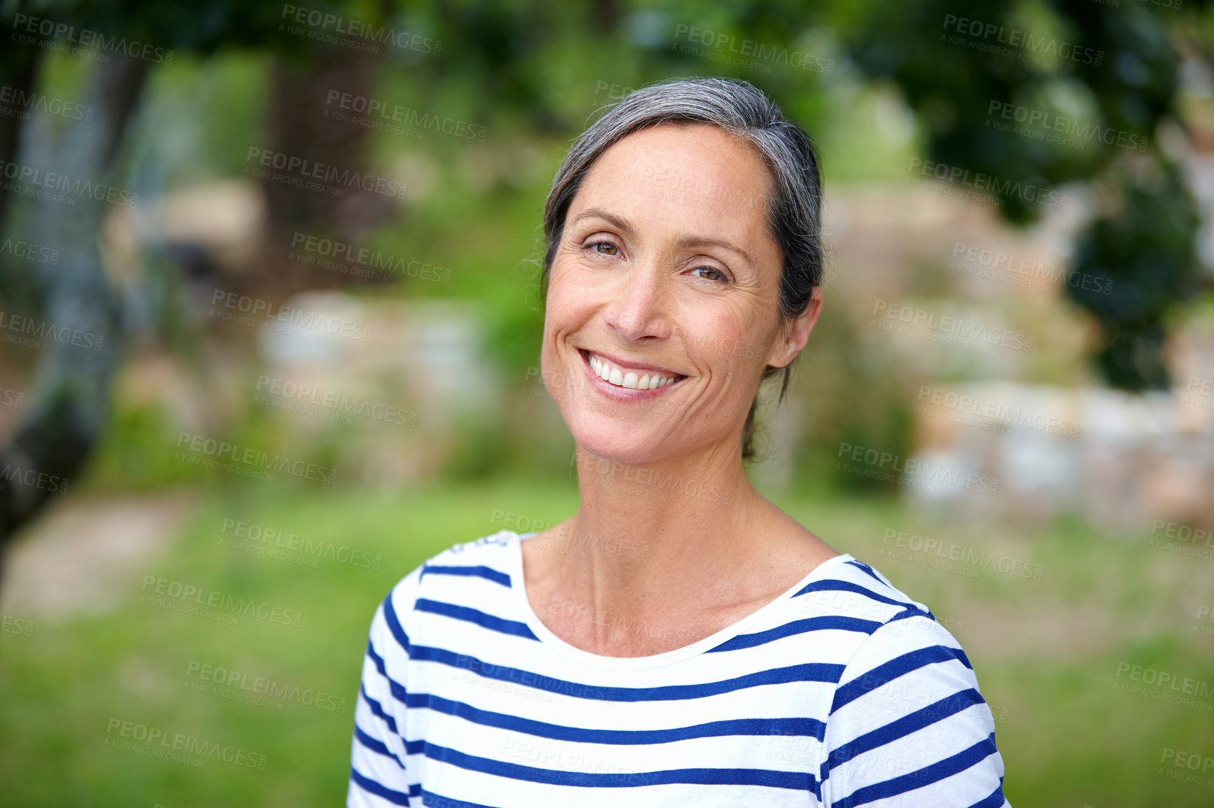 Buy stock photo Mature woman, happy and portrait in garden, nature and excited in backyard with sunshine in morning. Person, smile and outdoor with confidence, pride and break on lawn, summer and blur in Croatia