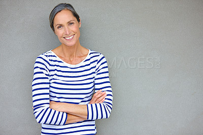 Buy stock photo Portrait of an attractive mature woman in casualwear standing against a gray wall