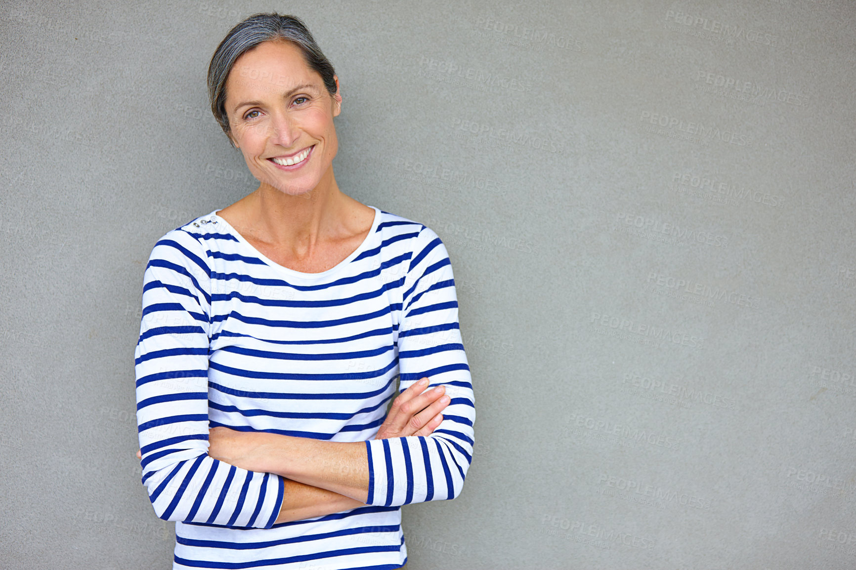 Buy stock photo Portrait of an attractive mature woman in casualwear standing against a gray wall