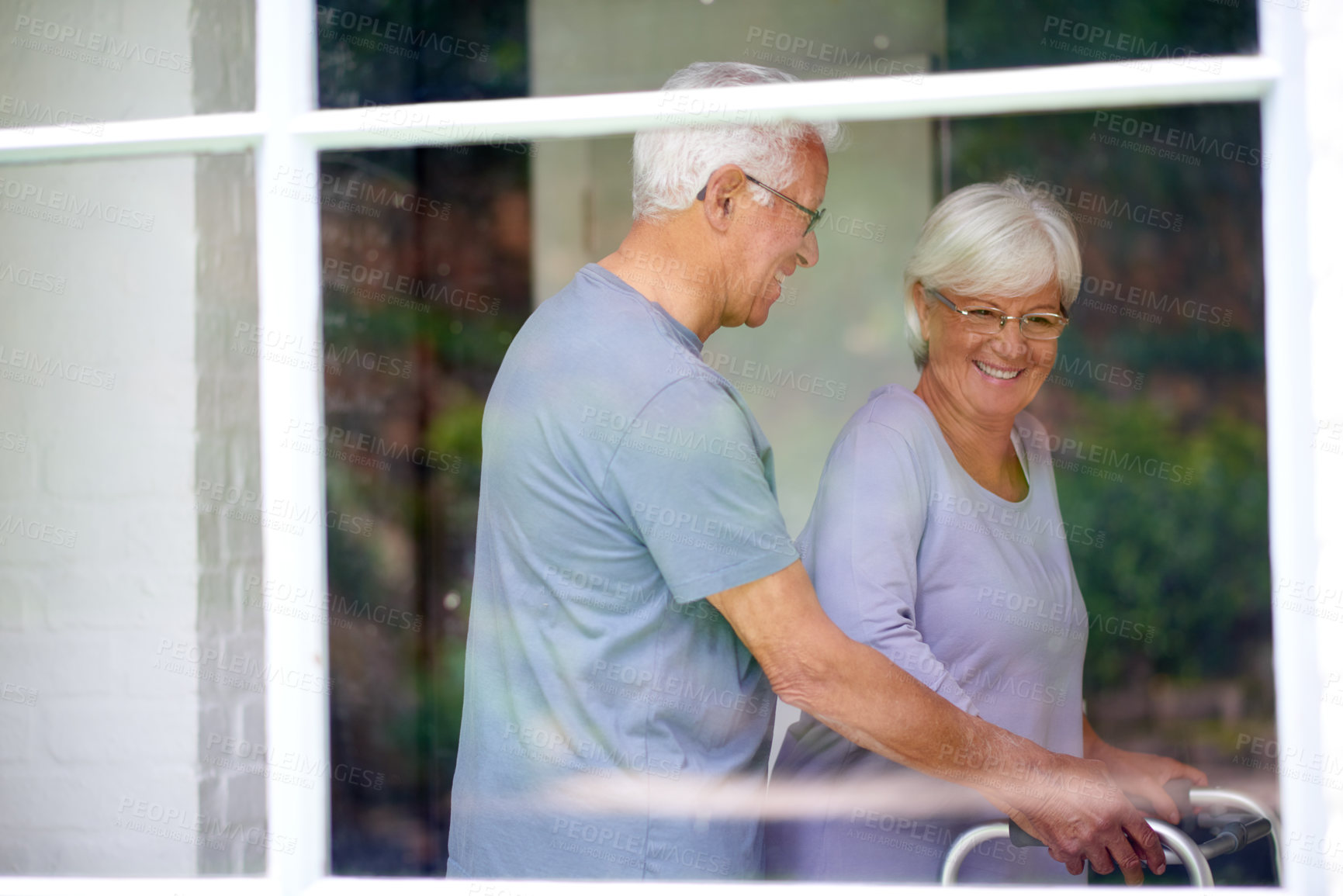 Buy stock photo Happy couple, senior or walker to help for support, love or care in home for health by window. Man, walking frame or assist elderly woman with disability for retirement, rehabilitation or recovery