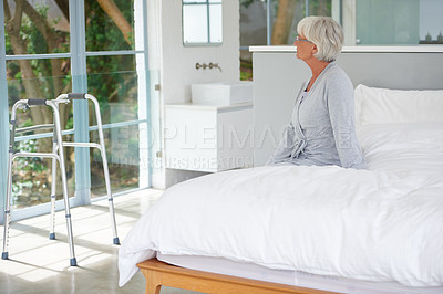 Buy stock photo Shot of a senior woman looking out of her room in a private clinic 