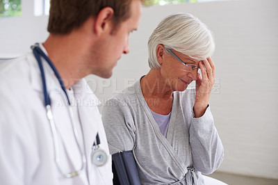 Buy stock photo Shot of a senior woman responding to bad news from her doctor