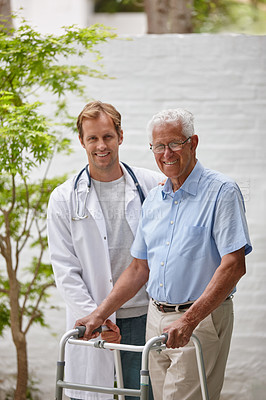 Buy stock photo Portrait of a male doctor standing with his senior patient who's using a walker for support outside