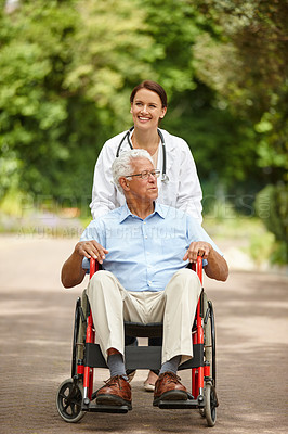 Buy stock photo Shot of a female doctor taking her senior patient for an outing in his wheelchair