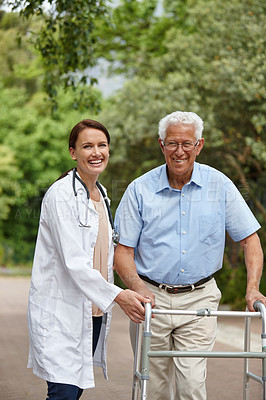 Buy stock photo Portrait of a female doctor standing with her senior patient who's using a walker for support outside