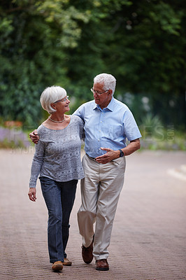 Buy stock photo Shot of a senior couple walking outdoors