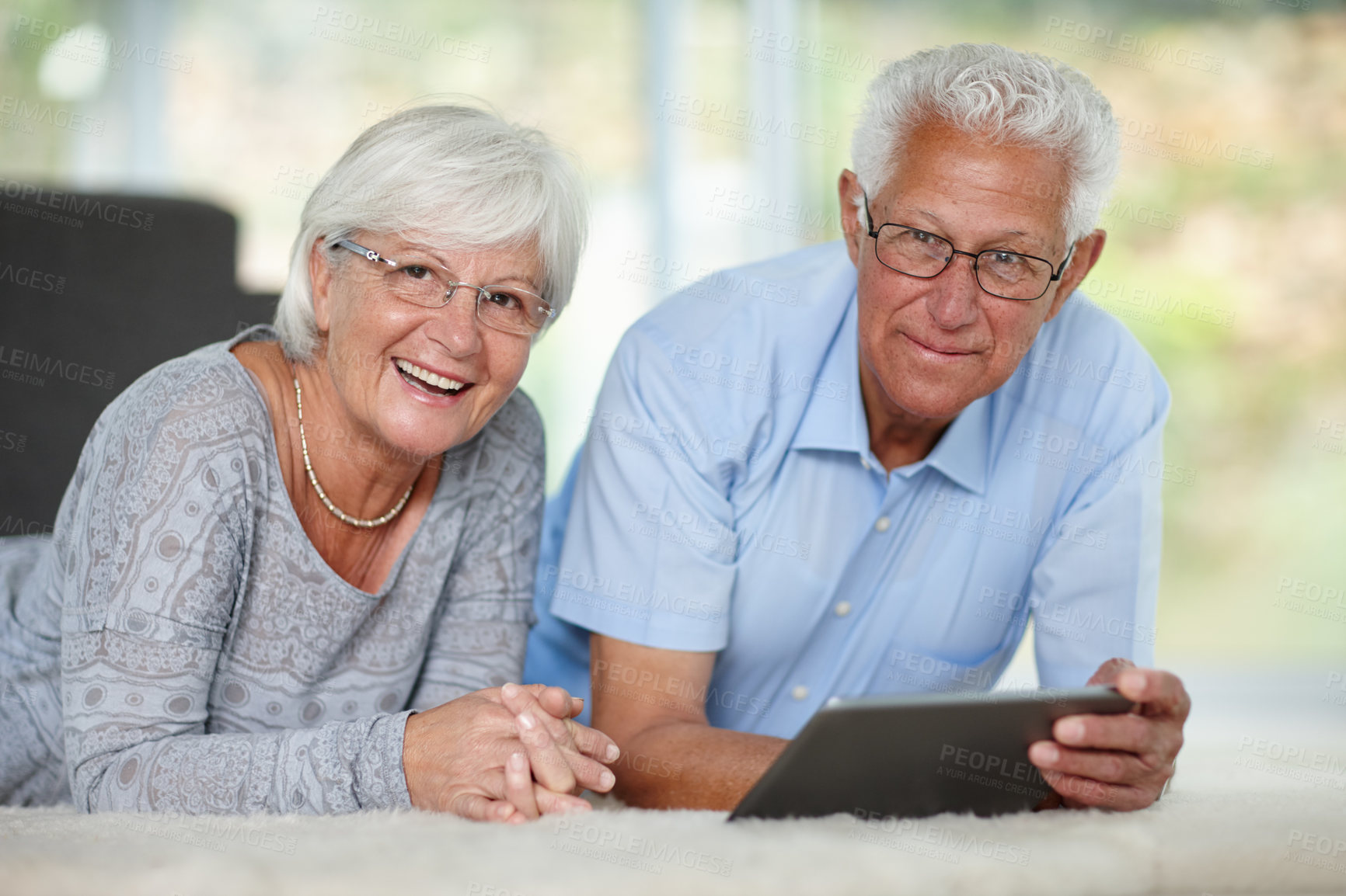 Buy stock photo Elderly couple, tablet and portrait in home for relax, online banking and memory app. Senior people, tech and happy in living room with connectivity, retirement research and communication in Canada