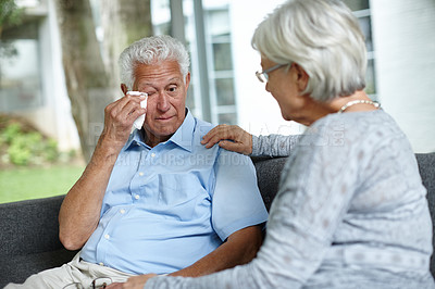 Buy stock photo Shot of a senior woman consoling her husband