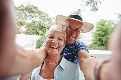 Buy stock photo Shot of a happy senior couple taking a selfie