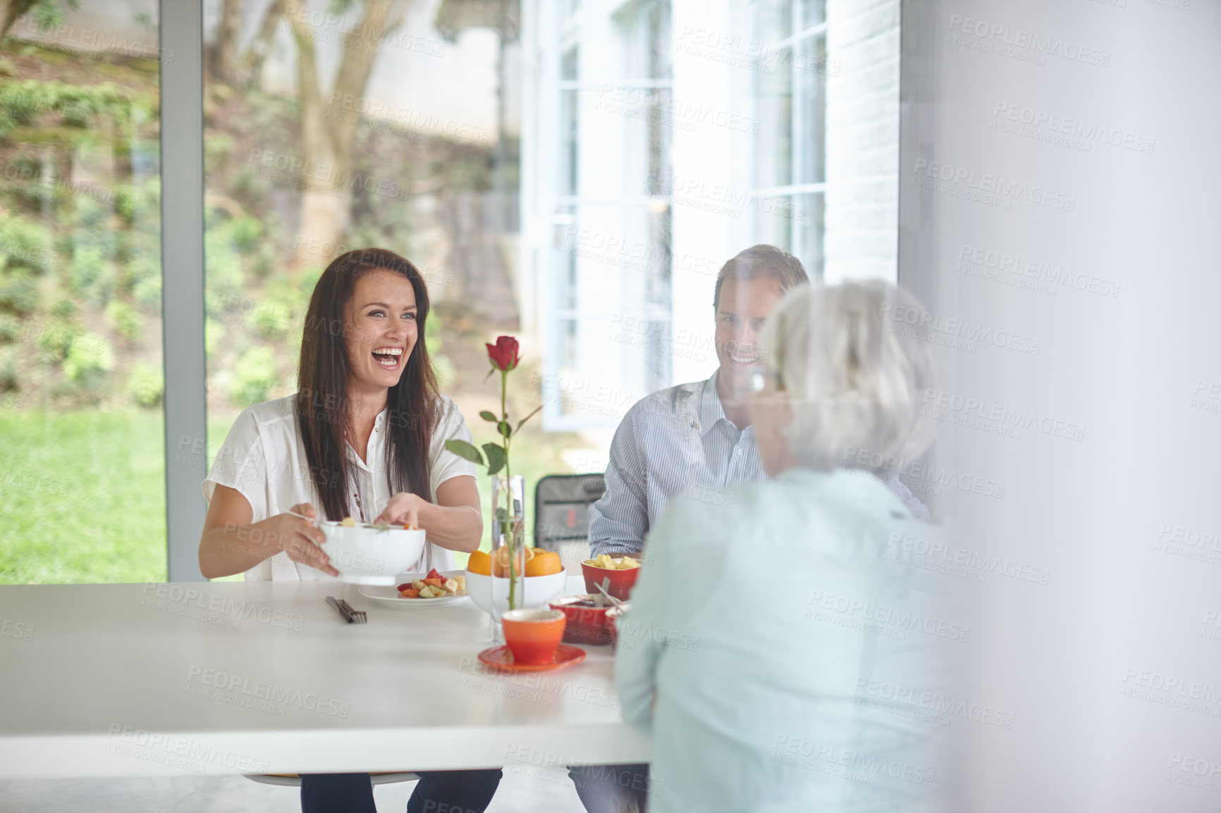 Buy stock photo Shot of a family eating together at home