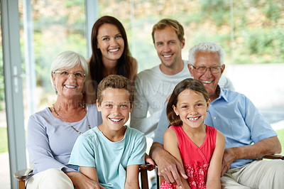 Buy stock photo Portrait of a loving multi-generational family sitting together indoors