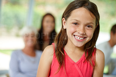 Buy stock photo Portrait of a cute little girl with her family in the background