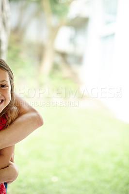 Buy stock photo Shot of a smiling young girl with arms around her neck