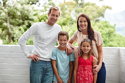 Buy stock photo Portrait of a happy family of four standing together outside